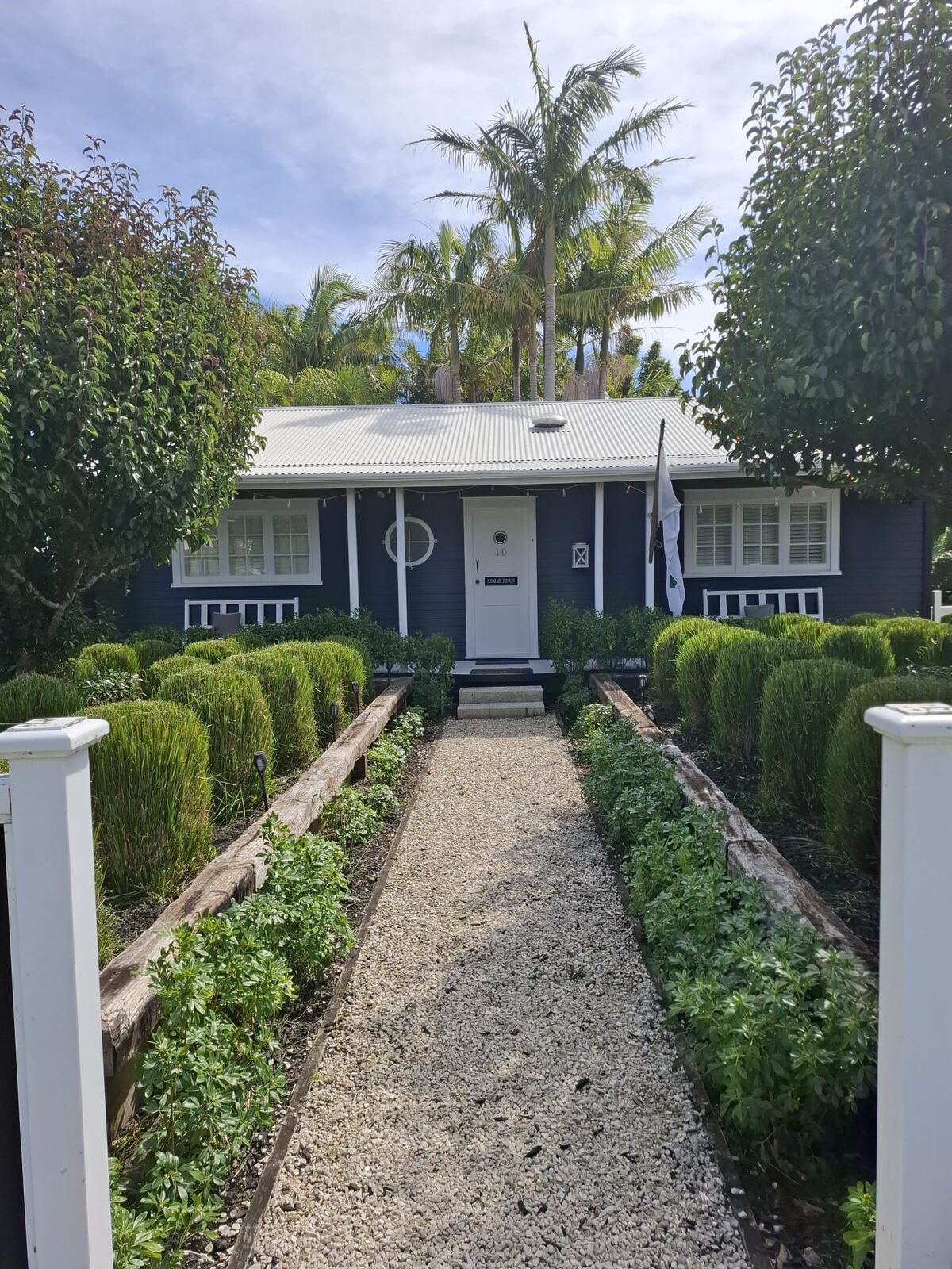Formal garden entrance with gravel path Waiheke